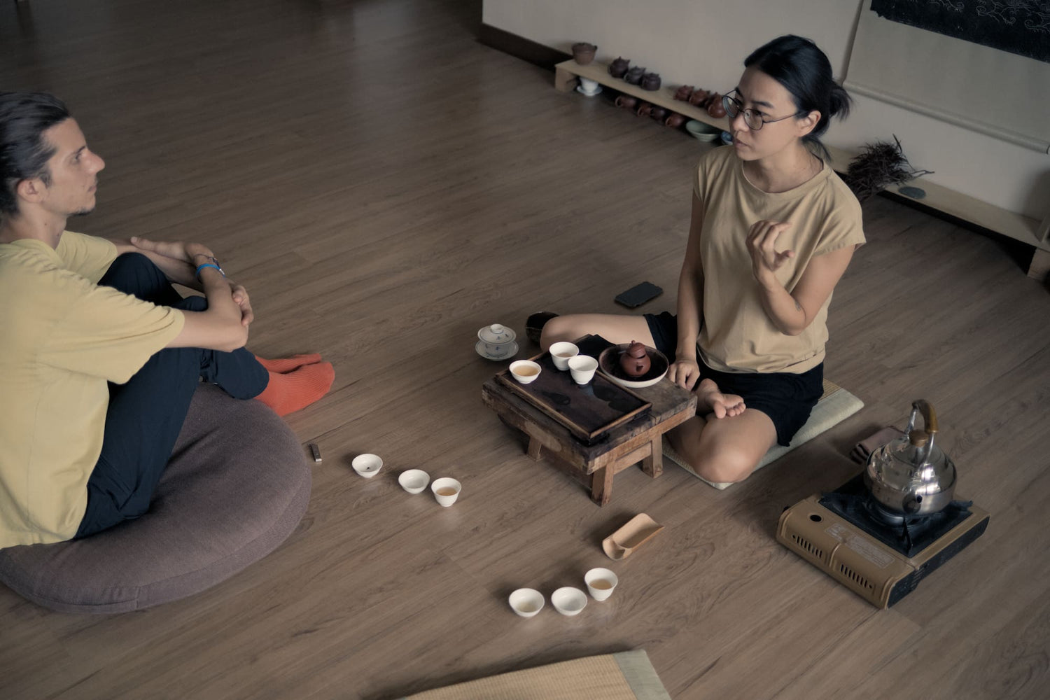 two people sitting in gongfu tea ceremony in a tea room