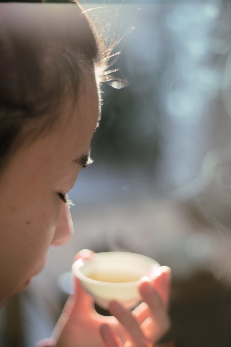 woman holding porcelain cup filled with wild farmed loose leaf tea