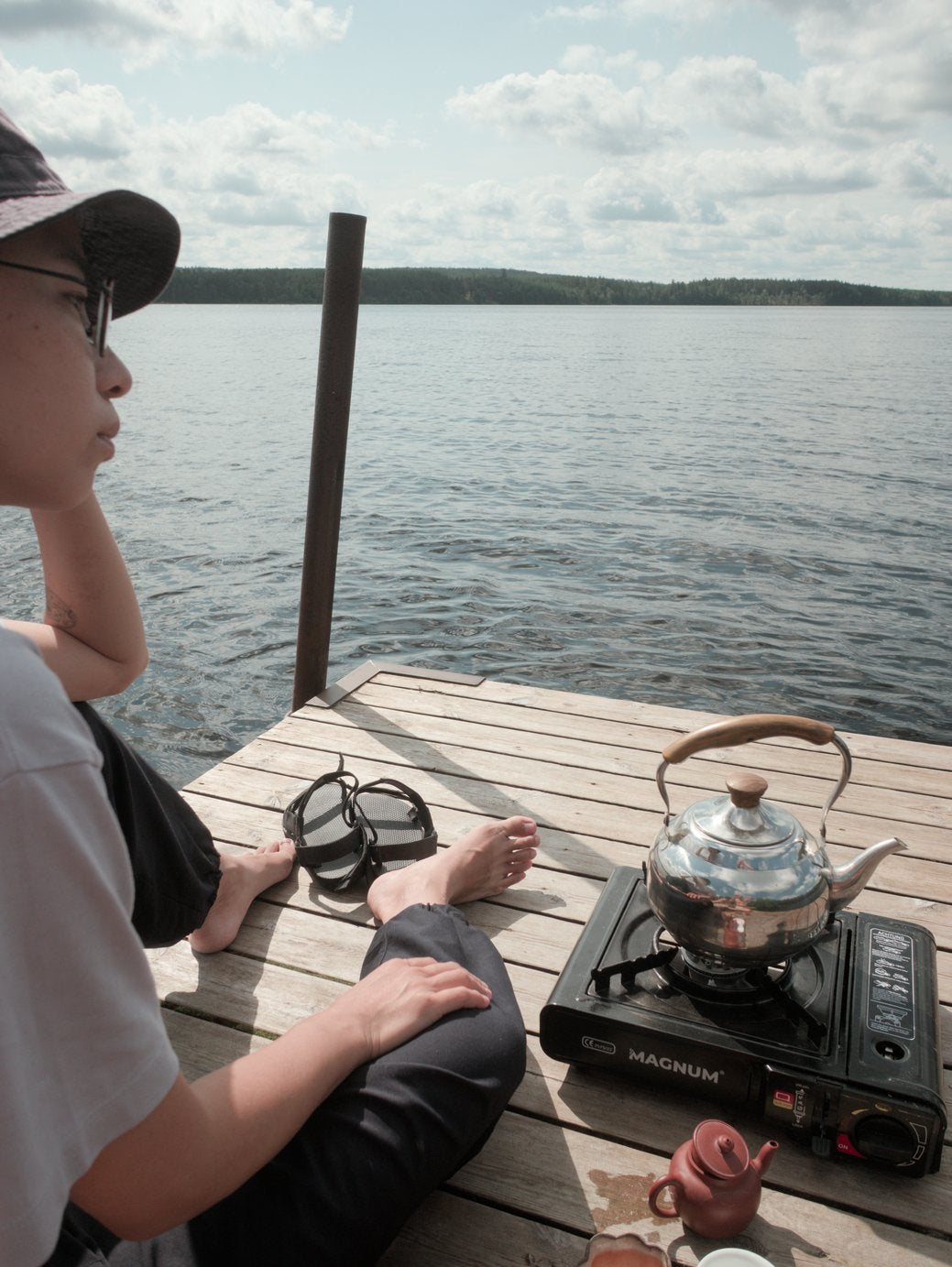 brewing wild farmed loose leaf tea in Zisha tea pot at a lake in Sweden