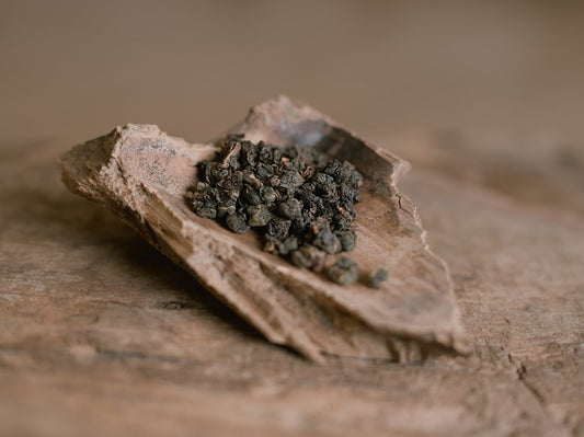 naturally farmed Dong Ding oolong tea on a wooden scoop