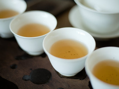 white porcelain cups filled with naturally farmed oolong tea