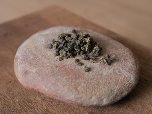 naturally farmed ball shaped oolong tea sitting on a rock