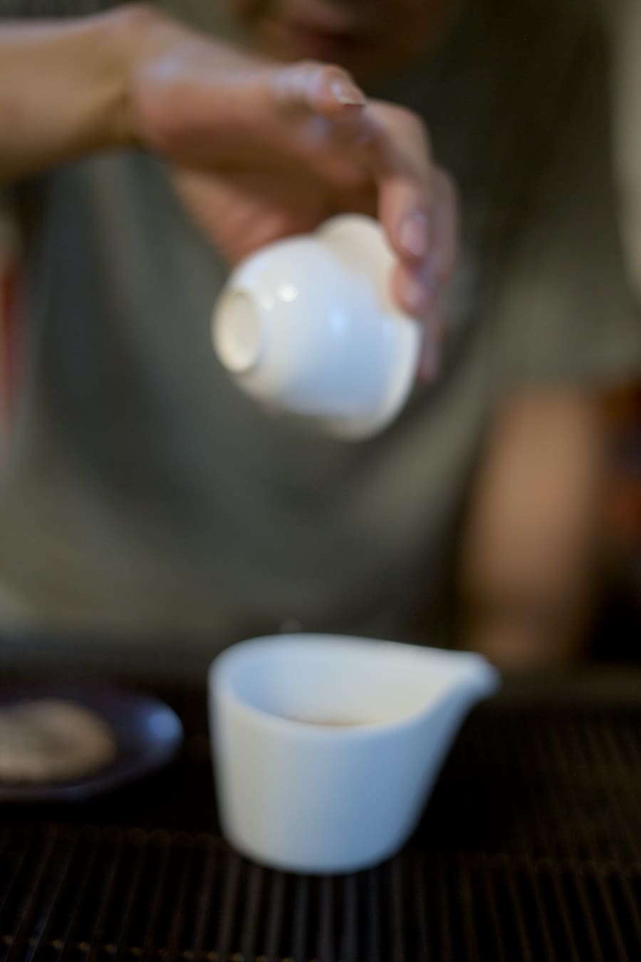 pouring tea out of white porcelain cup