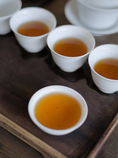 white porcelain cups filled with naturally farmed Ruby Red Jade black tea