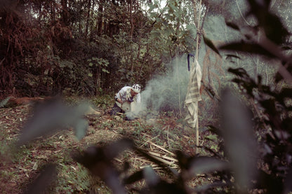 taiwanese tea master making fire in forest