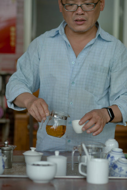 farmer pouring naturally farmed yellow tea