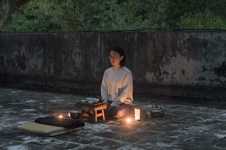 tea master in Gongfu tea meditation on rooftop in nature