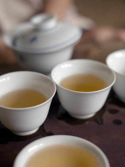 white porcelain cups filled with naturally farmed Tieguanyin oolong tea