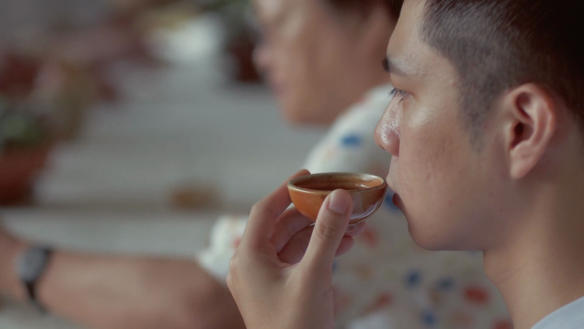 man sipping wild farmed tea from a cup in a ceramics studio in Taiwanese mountains